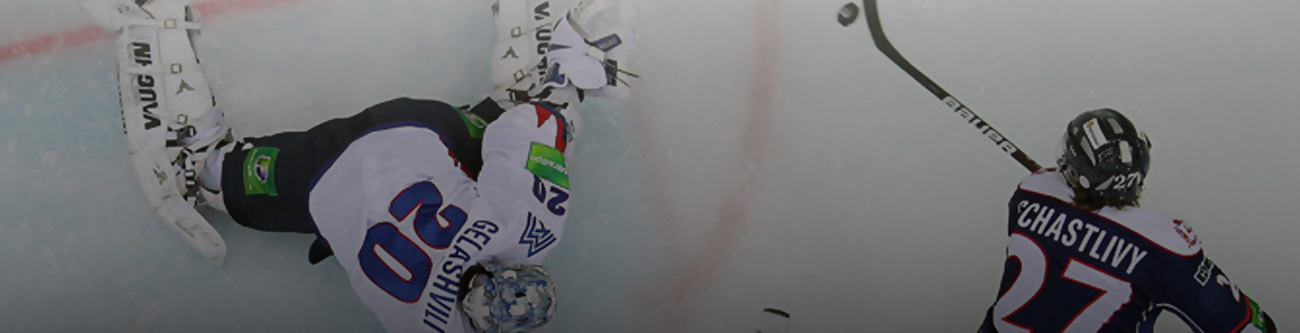 Хоккейный момент: вратарь на льду, готовый отразить шайбу, рядом игрок команды с клюшкой